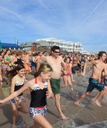 Swimmers running into cold water