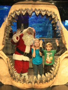Santa and kids in large fossil shark jaws